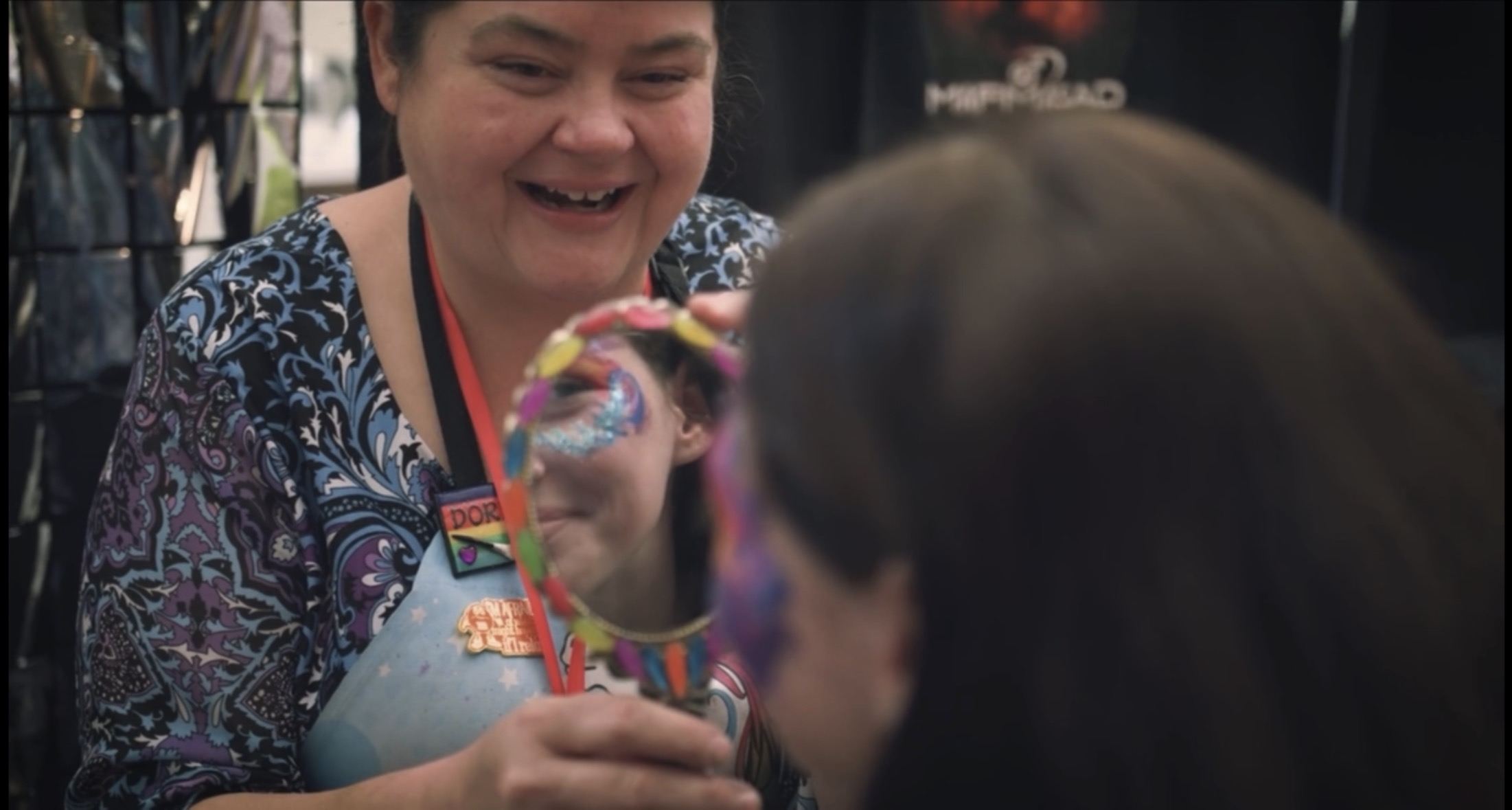 ConCon maker-vendor women with hand mirror